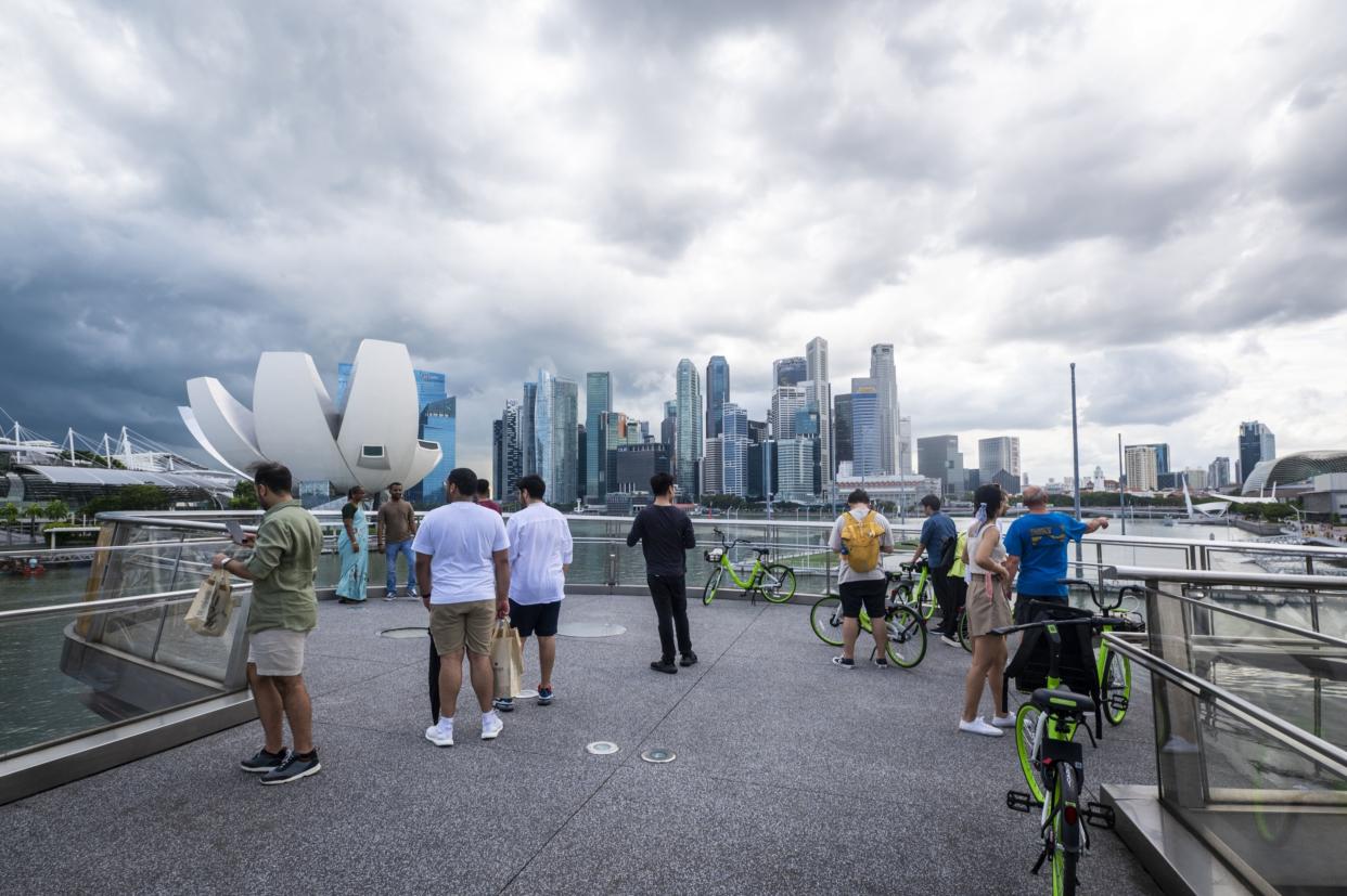 People take photographs at the Helix Bridge in Singapore, on Saturday, Feb. 11, 2023. (Edwin Koo/Bloomberg)