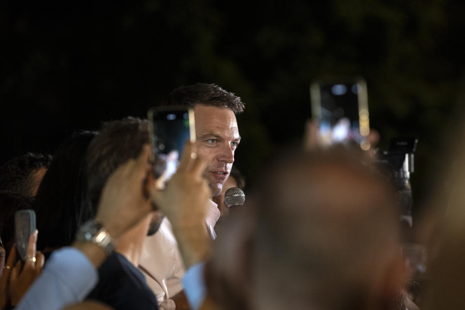 Stefanos Kasselakis, newly elected leader of main opposition party Syriza, speaks to supporters outside the party's headquarters in Athens, Greece, Monday, Sept. 25, 2023, after a runoff election for the left-wing bloc. (AP Photo/Yorgos Karahalis)