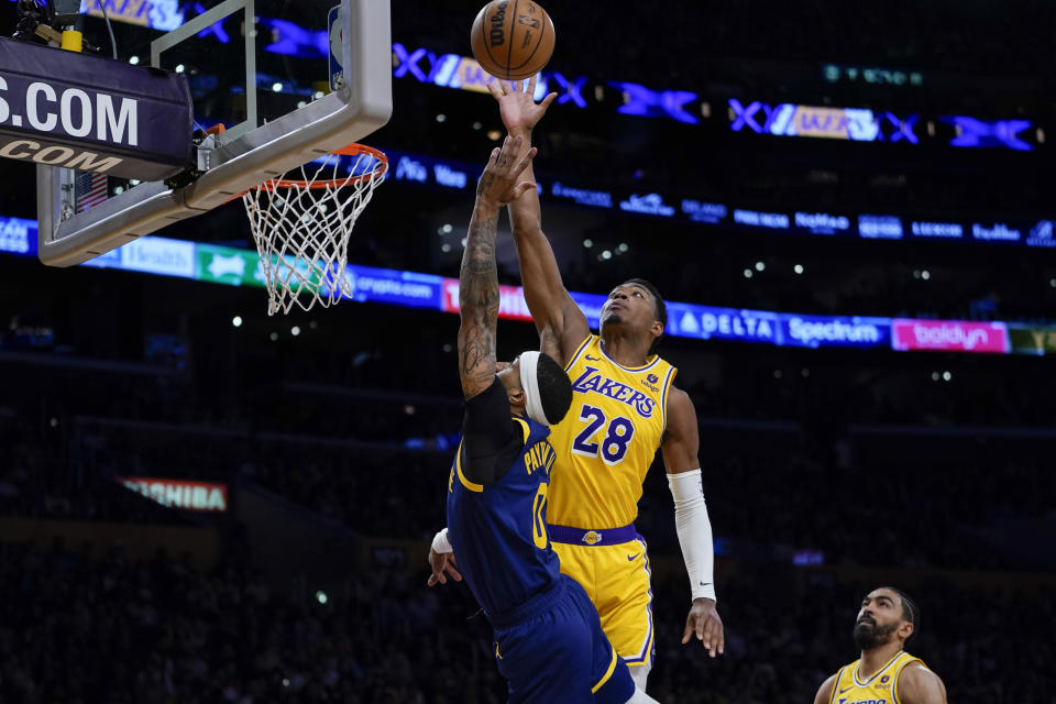 Los Angeles Lakers forward Rui Hachimura, right, blocks a shot attempt by Golden State Warriors guard Gary Payton II during the first half of an NBA basketball game Tuesday, April 9, 2024, in Los Angeles. (AP Photo/Ryan Sun)