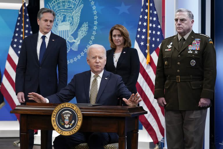 President Joe Biden speaks after signing a delegation of authority in the South Court Auditorium on the White House campus in Washington, Wednesday, March 16, 2022. From left, Secretary of State Antony Blinken, Biden, Deputy Secretary of Defense Kathleen Hicks and Chairman of the Joint Chiefs of Staff General Mark Milley. (AP Photo/Patrick Semansky)