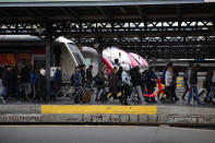 Commuters leave a train at the Gare de l'Est train station Monday, Dec. 23, 2019 in Paris. France's punishing transportation troubles may ease up slightly over Christmas, but unions plan renewed strikes and protests in January to resist government plans to raise the retirement age to 64. (AP Photo/Francois Mori)