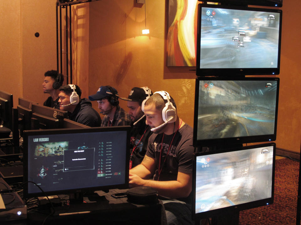 In this March 31, 2017 file photo, video game players compete against one another in an esports tournament at Caesars casino in Atlantic City, N.J. Atlantic City wants to become the East Coast capital of competitive video game tournaments, also known as esports. The activity is rapidly growing in popularity across the country and around the world. The New Jersey gambling resort wants to become a major player in the nearly $1 billion global market. (AP Photo/Wayne Parry, File)