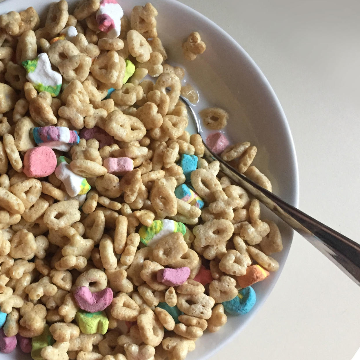 a spoon in a bowl of lucky charms