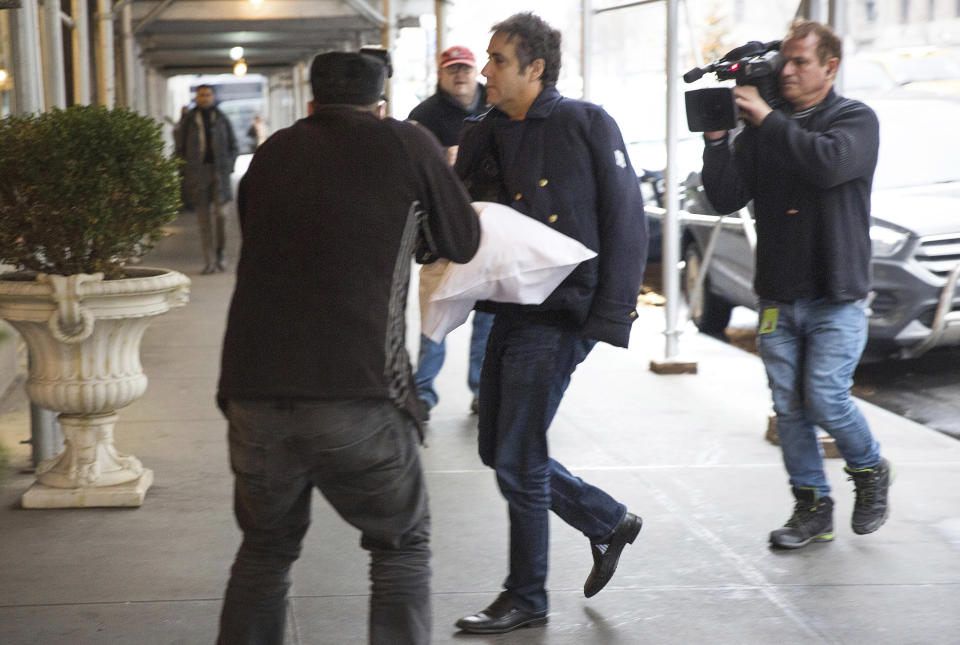 ADDS THAT COHEN'S LEFT ARM IS IN A SLING - Michael Cohen arrives at his home in New York with his left arm in a sling supported by a pillow Friday, Jan. 18, 2019. Democrats are vowing to investigate whether President Donald Trump directed Cohen, his personal attorney, to lie to Congress about a Moscow real estate project, calling that possibility a "concern of the greatest magnitude." (AP Photo/Kevin Hagen)