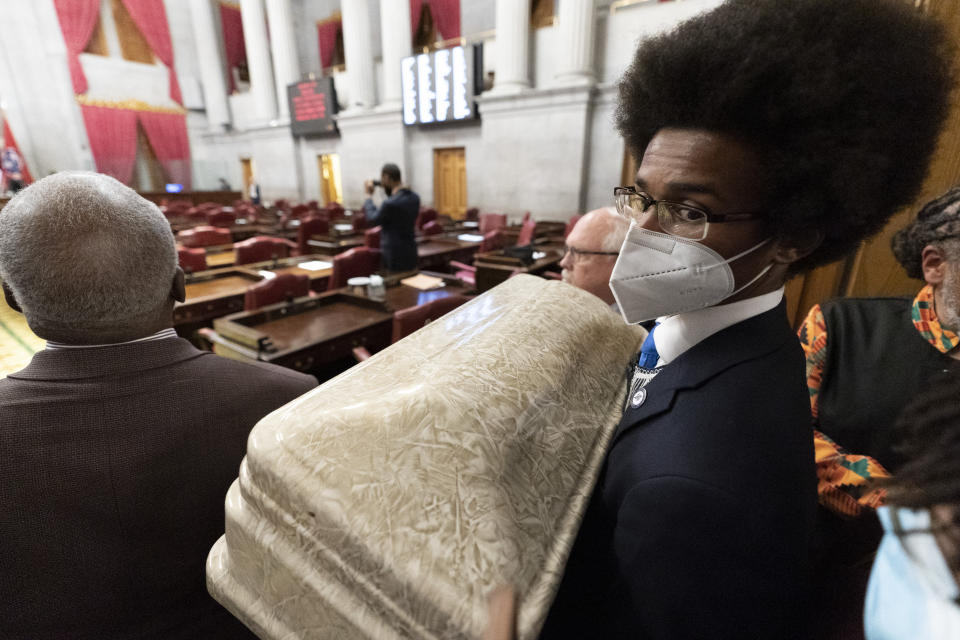 Rep. Justin Pearson, D-Memphis, holds a casket outside the House chambers Monday, April 17, 2023 in Nashville, Tenn. Pearson tried to bring a casket to the House floor, calling for lawmakers to support gun safety legislation. (AP Photo/George Walker IV)