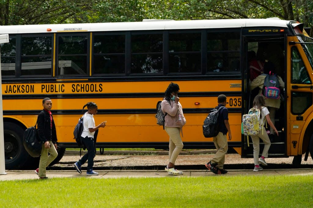 Spann Elementary School students board a school bus following a full day of in-school learning after having to again undertake virtual learning classes due to the city’s water issues that forced Jackson Public Schools to close for several days, Tuesday, Sept. 6, 2022, in Jackson, Miss. (AP Photo/Rogelio V. Solis)