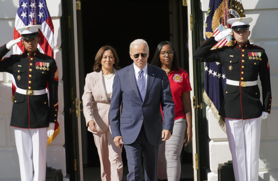 President Joe Biden arrives with Vice President Kamala Harris and Lovette Jacobs, a fifth-year IBEW Local 103 electrical apprentice in Boston, during a ceremony about the Inflation Reduction Act of 2022, on the South Lawn of the White House in Washington, Tuesday, Sept. 13, 2022. (AP Photo/Andrew Harnik)