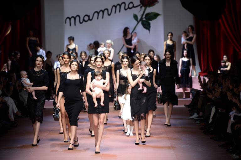 Italian actress Bianca Balti (2nd L) walks the catwalk with models at the end of the Dolce and Gabbana show on March 1, 2015 during Milan Fashion Week