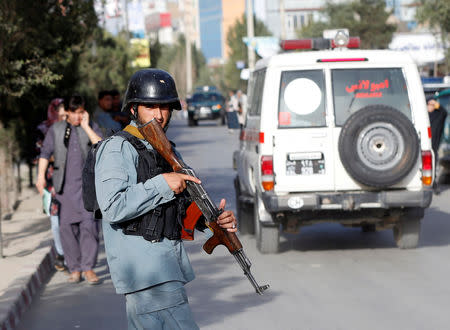 An Afghan policeman keeps watch near the site of a suicide bomb blast in Kabul, Afghanistan August 15, 2018. REUTERS/Omar Sobhani