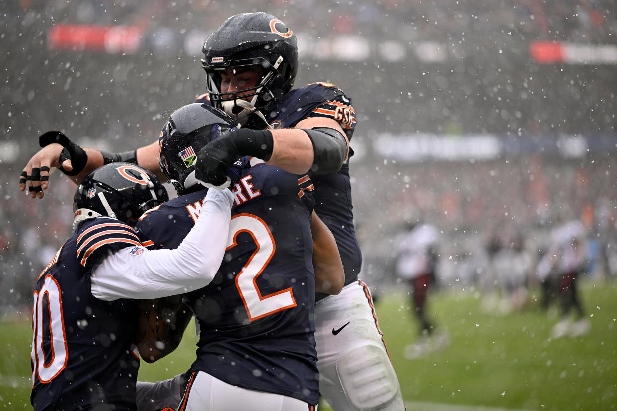 Collin Johnson #80, DJ Moore #2, and Lucas Patrick #62 of the Chicago Bears celebrate after Moore's receiving touchdown during the first quarter against the Atlanta Falcons at Soldier Field on December 31, 2023 in Chicago, Illinois.