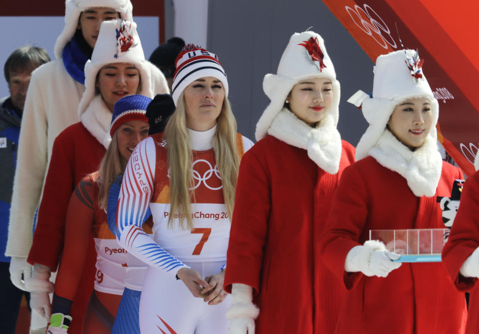 <p>Bronze medal winner United States’ Lindsey Vonn, center, walks to the flower ceremony for the women’s downhill at the 2018 Winter Olympics in Jeongseon, South Korea, Wednesday, Feb. 21, 2018. (AP Photo/Michael Probst) </p>