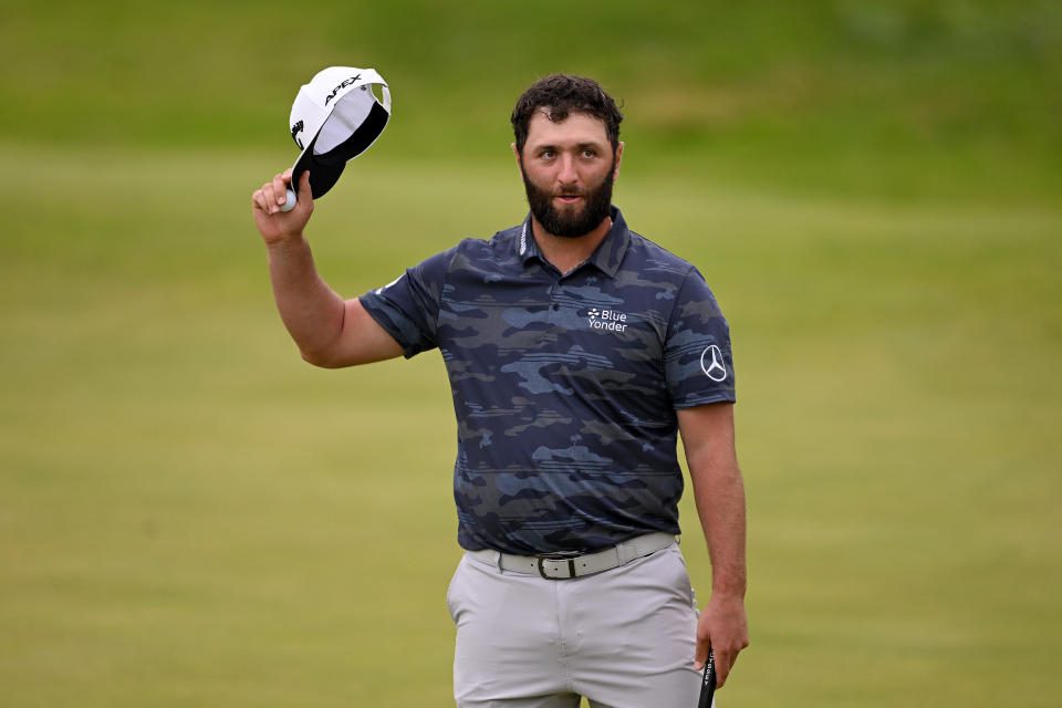 Jon Rahm of Spain raises their cap as they acknowledge the crowd after putting on the 18th green on Day Three of The 151st Open at Royal Liverpool Golf Club on July 22, 2023 in Hoylake, England. (Photo by Ross Kinnaird/Getty Images)