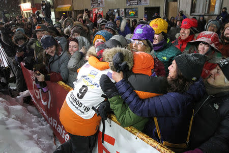 Pete Kaiser of of Bethel, Alaska embraces fans from his hometown after winning the Iditarod Trail Sled Dog Race after crossing the finish line in Nome, Alaska, U.S. March 13, 2019. REUTERS/Diana Haecker/Nome Nugget