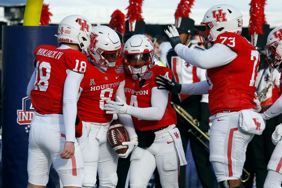 Houston Cougars wide receiver KeSean Carter (8) reacts with wide receiver Joseph Manjack IV (18), running back Ta'Zhawn Henry (4) and offensive linemen Cam'Ron Johnson (73) after catching a pass for a touchdown during the first half against the Louisiana-Lafayette Ragin' Cajuns in the 2022 Independence Bowl on Dec 23, 2022, at Independence Stadium.