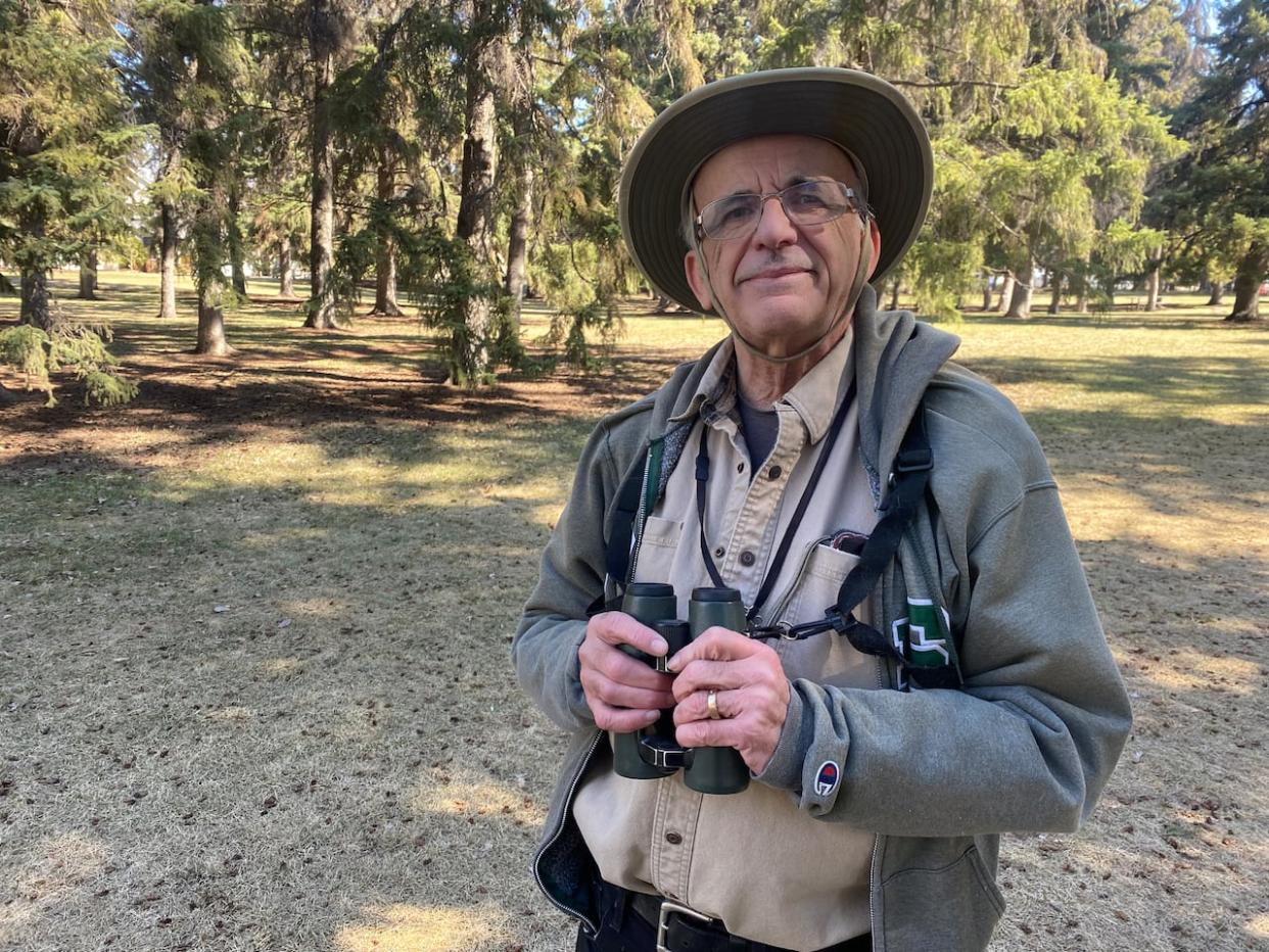 Stan Shadick of Saskatoon Custom Bird Tours spent part of Earth Day wandering through the spruce trees in his neighbourhood park in Saskatoon. (Jason Warick/CBC - image credit)