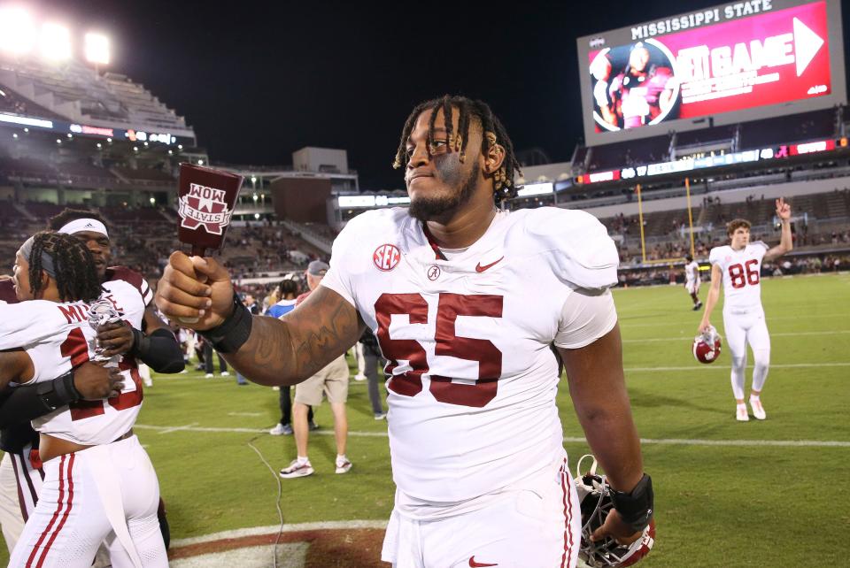 Sep 30, 2023; Starkville, Mississippi, USA; Alabama Crimson Tide offensive lineman JC Latham (65) celebrates with a cow bell in Davis Wade Stadium at Mississippi State University. Alabama defeated Mississippi State 40-17. Mandatory Credit: Gary Cosby Jr.-Tuscaloosa News