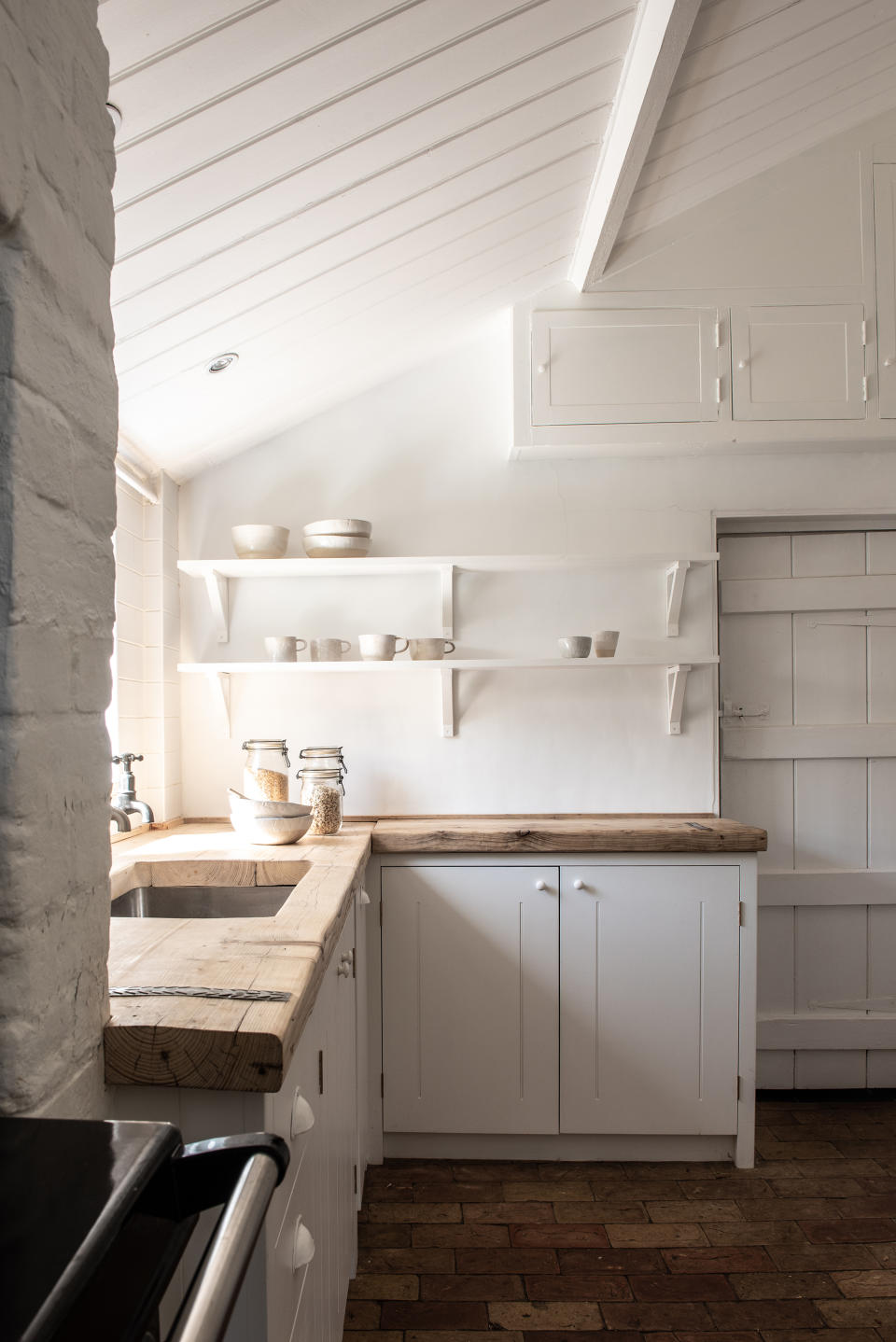 wooden worktops on white kitchen with open shelving