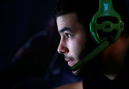 FILE PHOTO: Millenium eSport professional gamer Samir of France, nicknamed D1abloZeTank, looks at a computer screen as he plays inside the Millenium Gaming House in Marseille, France, November 13, 2013. REUTERS/Jean-Paul Pelissier/File Photo