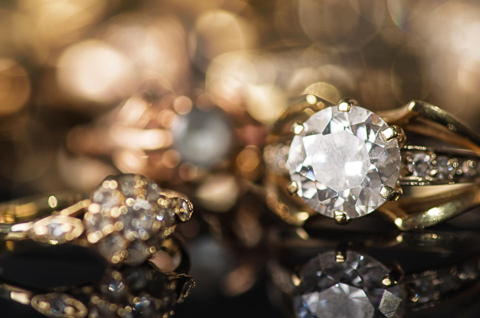 Gold jewelry on a black background.