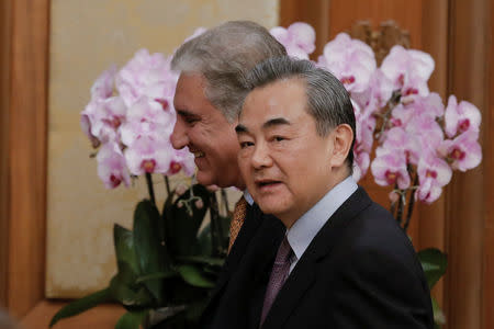 Chinese Foreign Minister Wang Yi and Pakistani Foreign Minister Shah Mehmood Qureshi leave a news conference at the Diaoyutai State Guesthouse in Beijing, China March 19, 2019. REUTERS/Thomas Peter