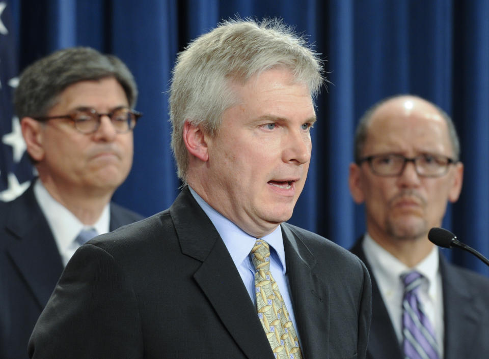 FILE - In this July 28, 2014, file photo, Public Trustee Charles Blahous speaks as then-Treasury Secretary and Managing Trustee Jacob Lew, left, and then-Labor Secretary Thomas Perez, right, listen during a news conference at the Treasury Department in Washington. A new study says ‘Medicare for all’ would raise government health care spending by $32.6 trillion over 10 years. “Enacting something like ‘Medicare for all’ would be a transformative change in the size of the federal government,” said Charles Blahous, the study’s author. Blahous was a senior economic adviser to former Republican President George W. Bush and a public trustee of Social Security and Medicare during the Obama administration. (AP Photo/Susan Walsh, File)