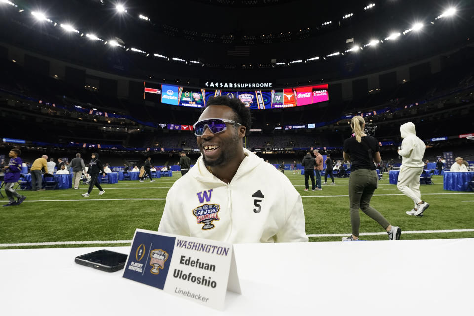 Washington linebacker Edefuan Ulofoshio talks to reporters during media day for the the upcoming Sugar Bowl NCAA CFP college football semi-final game against Texas in New Orleans, Saturday, Dec. 30, 2023. (AP Photo/Gerald Herbert)