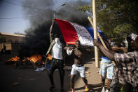 Protestors take to the streets of Burkina Faso's capital Ouagadougou Saturday Nov. 27, 2021, calling for President Roch Marc Christian Kabore to resign. The protest comes after the deadliest attack in years against the security forces in the Sahel's Soum province earlier this month, where more than 50 security forces were killed and after an attack in the Center North region where 19 people including nine members of the security forces were killed. (AP Photo/Sophie Garcia)