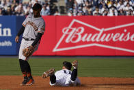 San Francisco Giants first baseman LaMonte Wade Jr., looks on as New York Yankees' Anthony Volpe (11) steals first base in the second inning of a baseball game, Saturday, April 1, 2023, in New York. (AP Photo/Mary Altaffer)