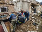 Police officers help rescue people from the rubble after an air strike in Bakhmut, Donetsk Region