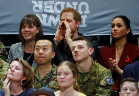 Britain's Prince Harry and Meghan, Duchess of Sussex, watch the Invictus Games Sydney 2018 wheelchair basketball gold medal match at Quaycentre in Sydney, Australia October 27, 2018. REUTERS/Phil Noble