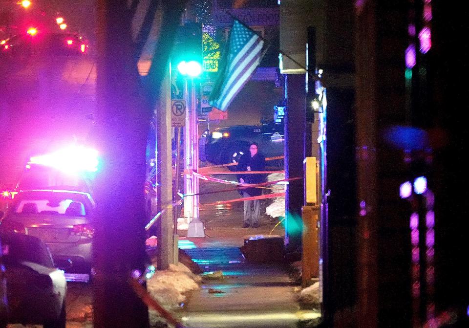 Police investigate the scene of a fatal officer involved shooting near the intersection of South 13th Street and West Cleveland Avenue in Milwaukee.