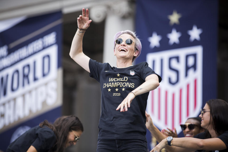 MANHATTAN, NY - JULY 10: Megan Rapinoe #15 of United States dances with the USA banner behind her during the ceremony on the steps of City Hall after the ticker tape parade down Broadway and through the through the Canyon of Heroes,.  This celebration was put on by the City of Manhattan to honor the team winning the 2019 FIFA World Cup Championship title, their fourth, played in France against Netherlands, at the City Hall Ceremony in the Manhattan borough of New York on July 10, 2019, USA.  (Photo by Ira L. Black/Corbis via Getty Images)