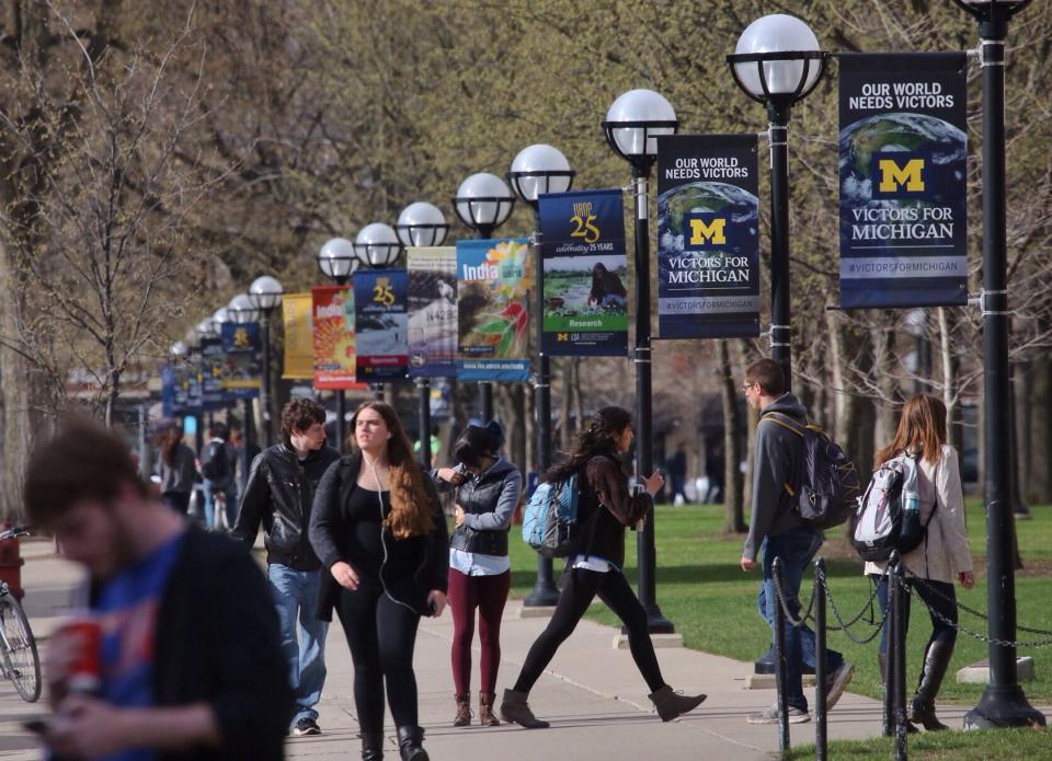 Students walk along South State Street through the Ann Arbor campus of the University of Michigan in this 2014 file photo. A Court of Appeals panel sided with U-M for a second time, ruling that the school's policy banning firearms from being carried on campus is not unconstitutional.