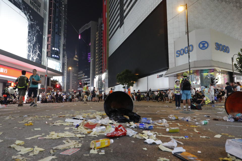 Protestors sit on a littered street in Hong Kong, Oct. 1, 2019. (Photo: Vincent Thian/AP)