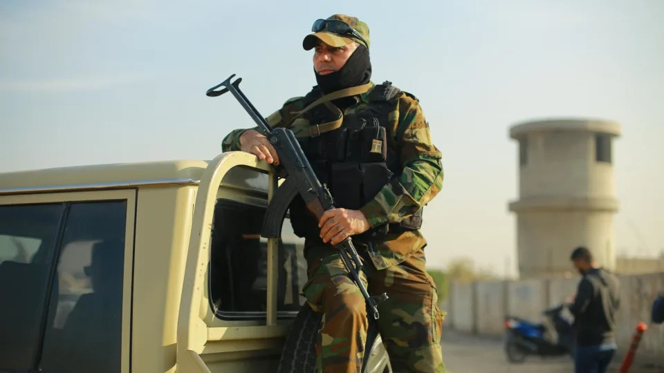 PHOTO: A member of the Popular Mobilization Forces (Hashed al-Shaabi), a powerful pro-Iranian militia, stands guard at the site where two members of the militia, including a commander, were killed in an alleged US airstrike, Jan. 4, 2024, Bagdad. (Ameer Al-Mohammedawi/picture alliance via Getty Images, FILE)