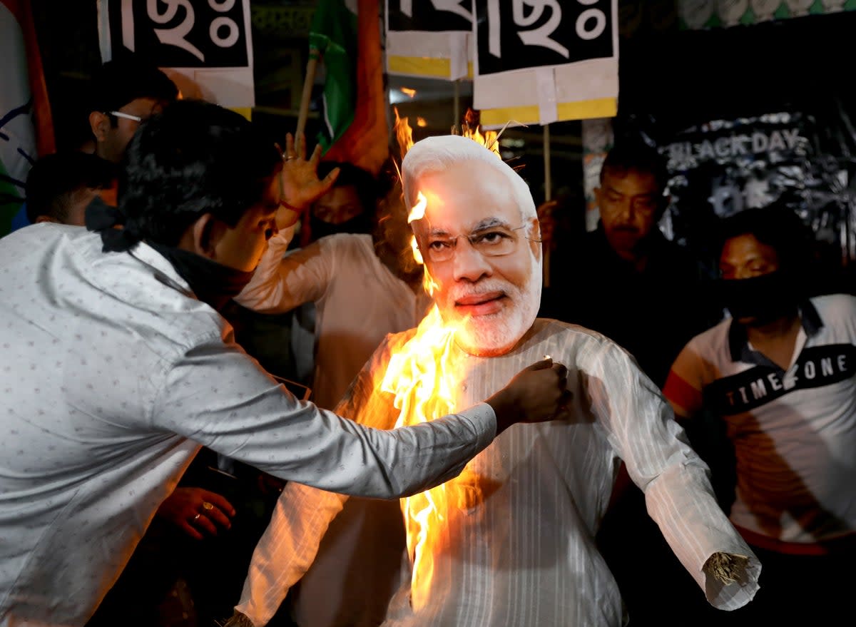 Supporters of the opposition Congress Party burn an effigy of Indian prime minister Narendra Modi (EPA)