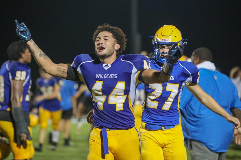 Richlands' CJ McDonald (44) and Chris Exley (27) celebrate the Wildcats' 7-6 win over Southwest in August.