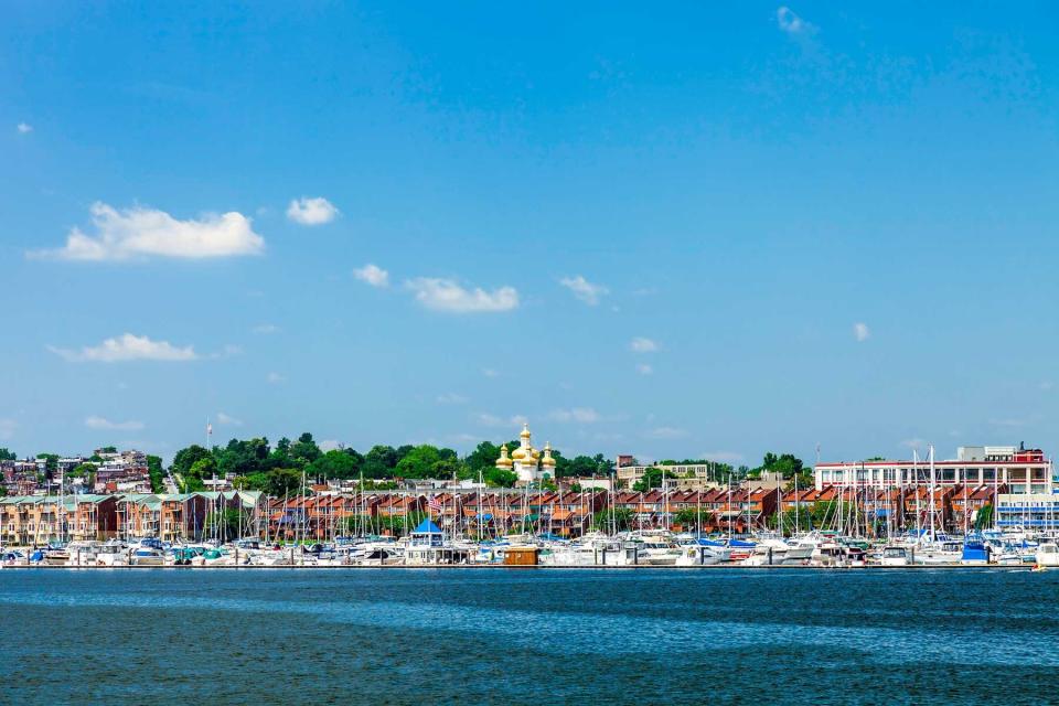 The Baltimore Inner Harbor Area where a Marina is enjoyed by many boaters and the gold topped St. Michael Ukrainian Orthodox Church on Eastern Avenue can be seen in the background.