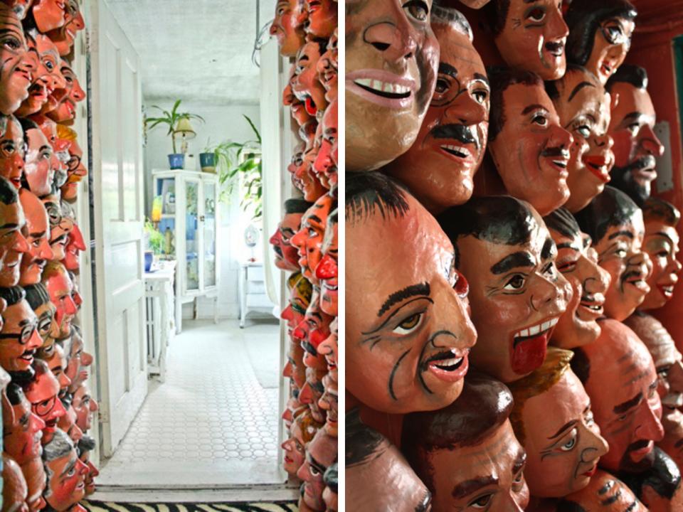 Face masks from Ecuador line the walls of the hallway.