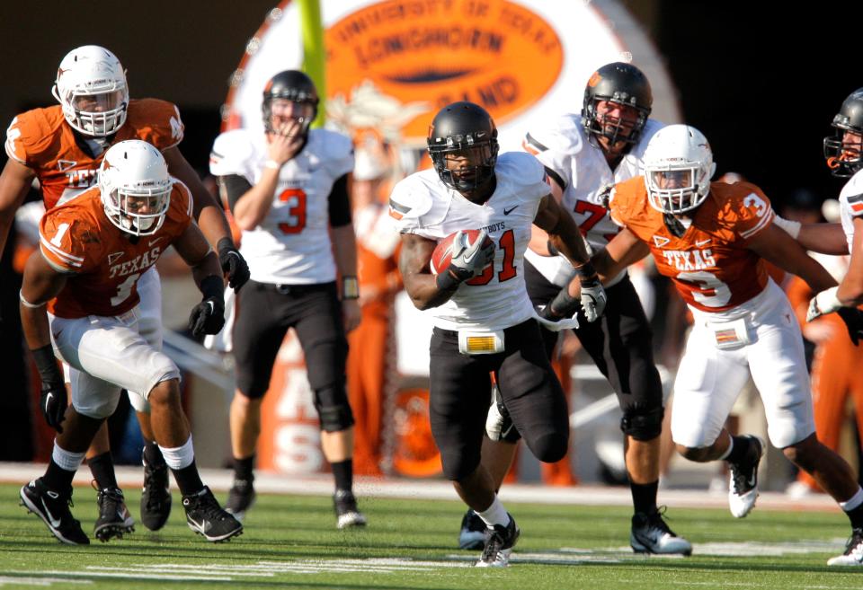 Oklahoma State's Jeremy Smith (31)gets through the Texas defense during second half of a college football game between the Oklahoma State University Cowboys (OSU) and the University of Texas Longhorns (UT) at Darrell K Royal-Texas Memorial Stadium in Austin, Texas, Saturday, Oct. 15, 2011.