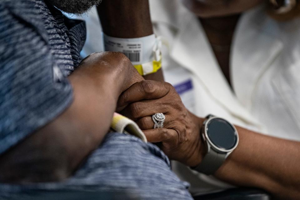 Chet Lemon, left, holds his wife, Gigi Lemon's, hand as their family get together to share memories at Encompass Health Rehabilitation Hospital in Clermont, Fla., on Thursday, May 23, 2024.