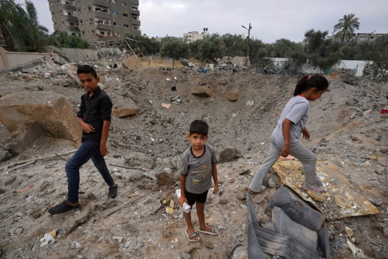 Palestinian children near the crater left by an Israeli strike in Nuseirat in the central Gaza Strip on June 3, 2024 (Bashar TALEB)