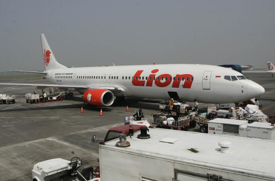 FILE- A Lion Air passenger jet plane is parked on the tarmac at Juanda International Airport in Surabaya, Indonesia, in this file photo dated May 12, 2012. Indonesian airline Lion Air is to buy 234 short to medium range aircraft from Airbus it is announced Monday March 18, 2013, for euro 18.4 billion (US dlrs24 billion), in what is being billed as the biggest civilian deal in the history of the aircraft manufacturer. The contract was announced Monday at the French presidential palace, a sign of the deal’s importance to the French government, and helping to secure around 5,000 jobs at a time when French unemployment hovers over 10 percent. (AP Photo/Trisnadi, File)