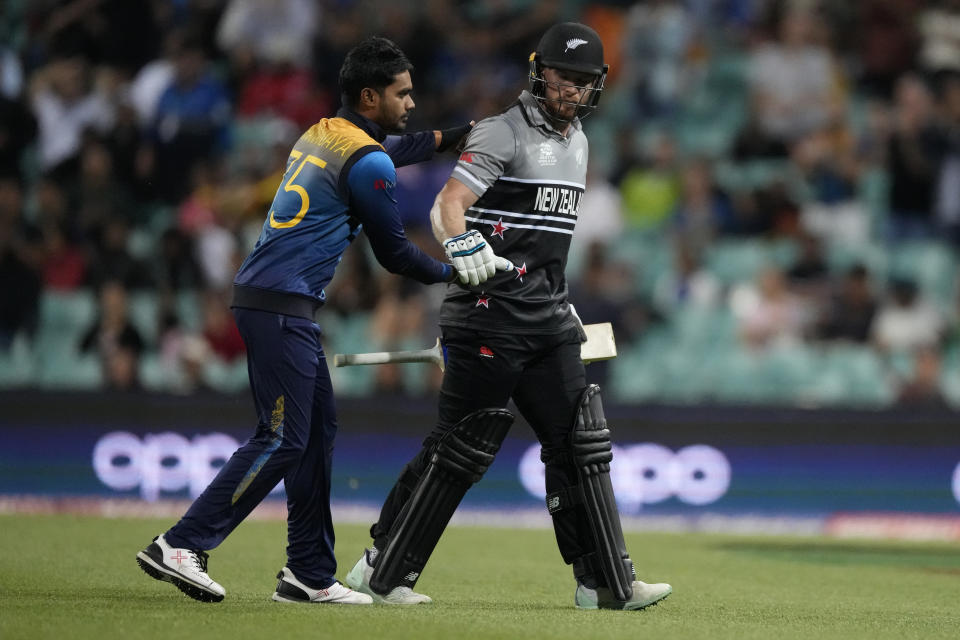 New Zealand's Glenn Phillips, right, is congratulated by Sri Lanka's Dhananjaya de Silva after scoring a century against Sri Lanka during their T20 World Cup Cricket match in Sydney, Australia, Saturday, Oct. 29, 2022. (AP Photo/Mark Baker)