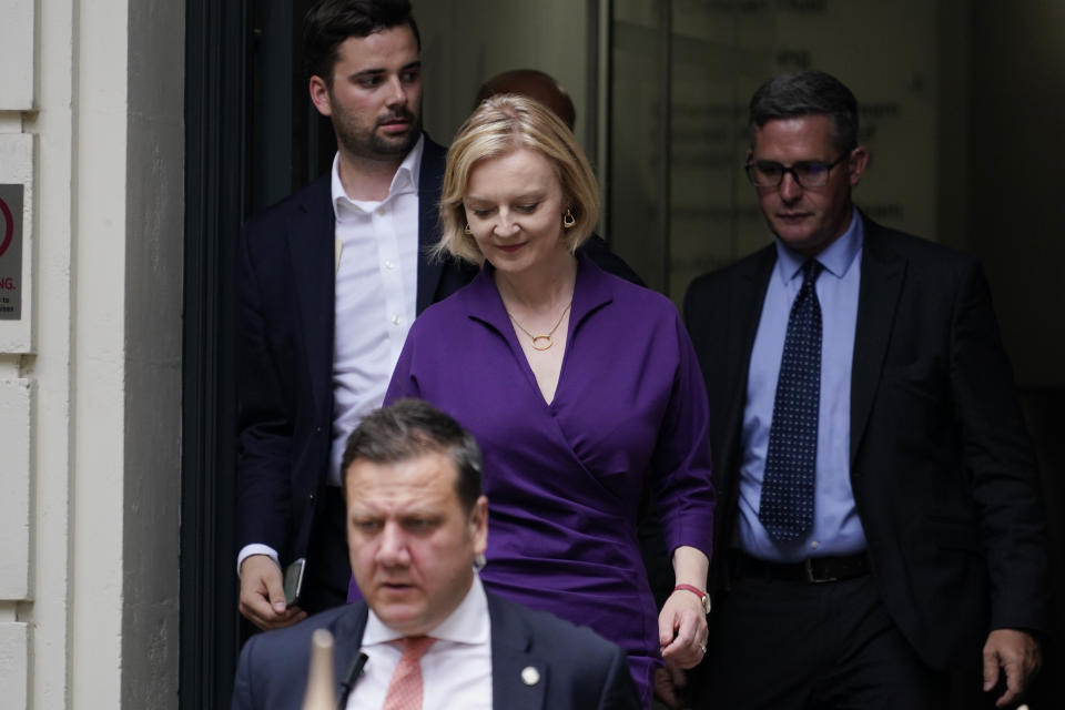 Liz Truss, centre, leaves the Conservative Central Office in Westminster after winning the Conservative Party leadership contest in London, Monday, Sept. 5, 2022. Liz Truss will become Britain's new Prime Minister after an audience with Britain's Queen Elizabeth II on Tuesday Sept. 6. (AP Photo/Alberto Pezzali)