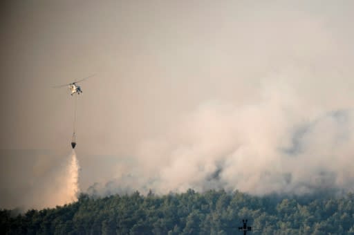 Over 200 firefighters were on the front line on Greece's second largest island, backed by 75 fire trucks, nine water-bombing helicopters and seven planes