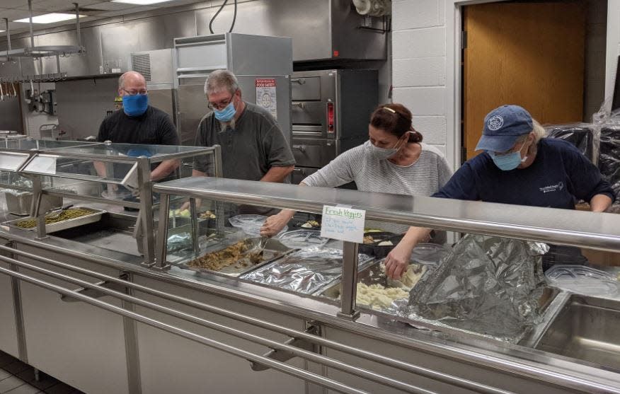 Volunteers put together meals for guests during the Free Community Thanksgiving Dinner in Elmore in 2020. This year the meal will be offered as a dine-in dinner for the first time since the pandemic.