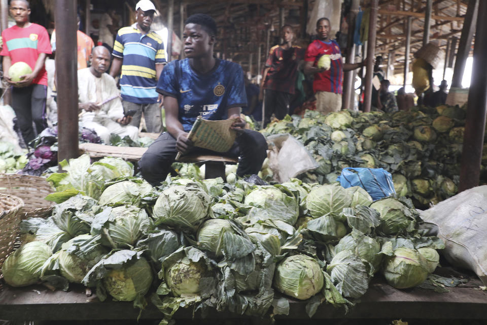 People sell cabbages at the Mile 12 Market in Lagos, Nigeria, Friday, Feb. 16, 2024. Nigerians are facing one of the West African nation's worst economic crises in as many years triggered by a surging inflation rate which follows monetary policies that have dipped the local currency to an all-time low against the dollar, provoking anger and protests across the country. (AP Photo/Mansur Ibrahim)