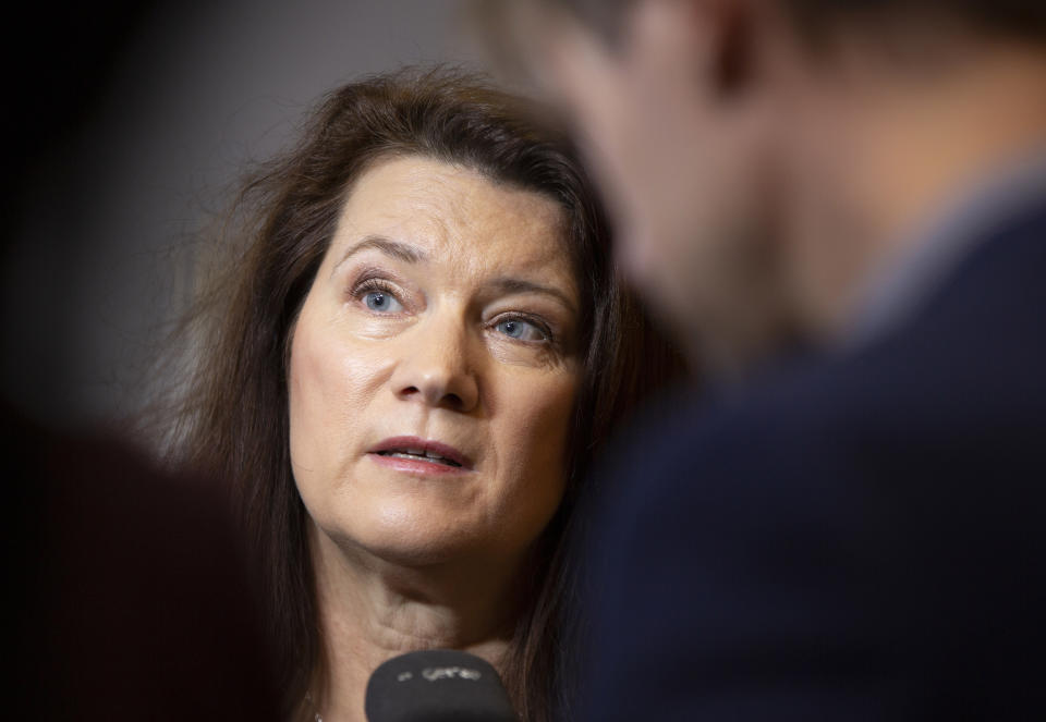 Swedish Foreign Minister Ann Linde, center, speaks with journalists as she arrives for a meeting of EU foreign ministers at the Europa building in Brussels, Monday, Dec. 9, 2019. European Union foreign ministers are debating how to respond to a controversial deal between Turkey and Libya that could give Ankara access to a contested economic zone across the Mediterranean Sea. (AP Photo/Virginia Mayo)