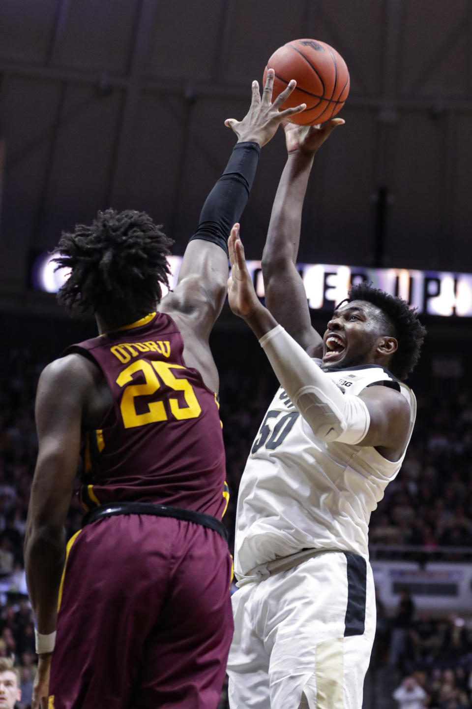 Purdue forward Trevion Williams (50 shoots over Minnesota center Daniel Oturu (25) during the second half of an NCAA college basketball game in West Lafayette, Ind., Thursday, Jan. 2, 2020. Purdue defeated Minnesota 83-78 in double overtime. (AP Photo/Michael Conroy)